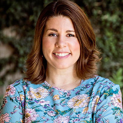 Amanda, Business Manager and Owner of Linrose Dental, smiling in a floral blouse against a natural background, representing the practice's commitment to patient care and comfort.