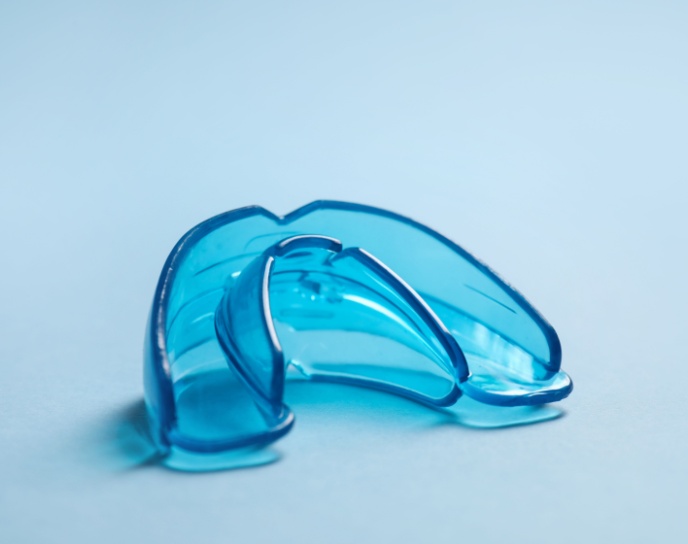 Custom blue mouthguard for sports protection and nighttime teeth grinding, highlighting personalized dental care at Linrose Dental.
