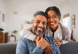 Smiling couple enjoying life together, representing the positive outcomes of dental care and implants at Linrose Dental.